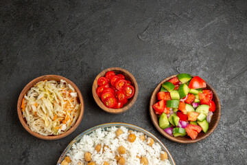 Seasoned split peas and rice for dinner and sauerkraut and salad on dark background stock image