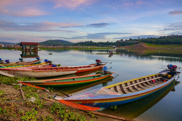 Obraz premium Sunrise with fishing boat on the lakes. Beautiful view in the countryside. 