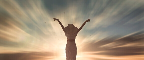 Silhouette woman with hands rise up on beautiful view. Christian praise on hill thanksgiving day...