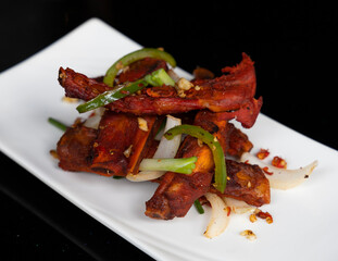 Salt and chili pork spare ribs with peppers, onions and garlic