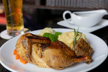 Half roast chicken with a sage and onion stuffing, served with mashed potato, seasonal vegetables and traditional gravy
