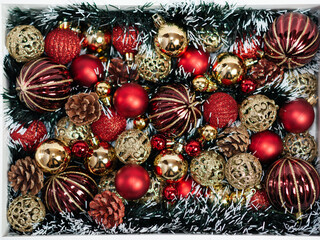 Red and gold Christmas decorations on the Christmas tree in a white box. Close up. Holiday. Happy Christmas.