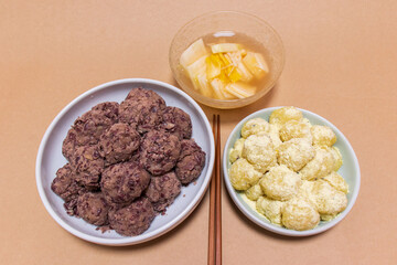 Rice cakes made with bean flour and mashed adzuki beans, Watery Kimchi (mulgimchi, mulkimchi), Korean traditional food, dessert, Injeolmi, tteok, homemade food.