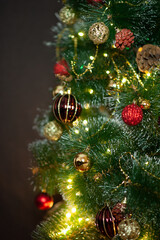 christmas tree in red and gold decorations on a brown background. Gift boxes. Happy Christmas. Side.