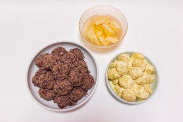 Rice cakes made with bean flour and mashed adzuki beans, Watery Kimchi (mulgimchi, mulkimchi), Korean traditional food, dessert, Injeolmi, tteok, homemade food.