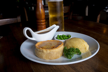 British pie served with potato mach, peas and gravy. 
Pub food