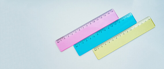multicolored school rulers on a light background