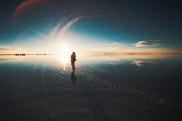 person on the lake at sunset