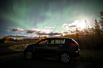 Fototapeta na wymiar car in the night with aurora borealis