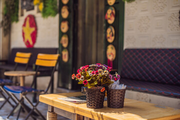 Vietnamese cafe with flowers and Vietnamese flag on background