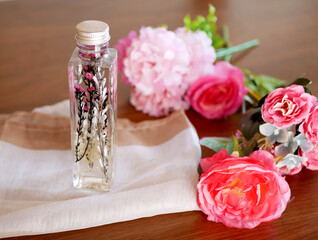 窓辺に置かれたハーバリウムと花束