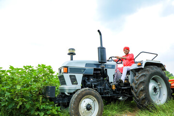 Indian farmer working with tractor at field © PRASANNAPIX