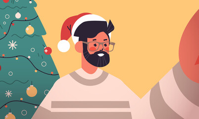 happy man in santa hat holding camera and taking selfie near fir tree new year christmas holidays celebration concept horizontal portrait vector illustration