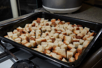 Square toasted pieces of homemade delicious rusk, hardtack, Dryasdust, zwieback on a baking sheet.