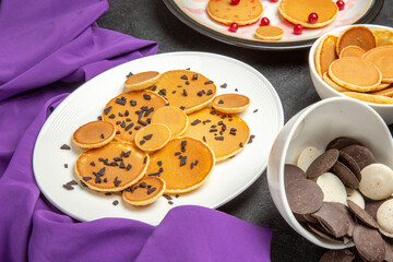 front view yummy little pancakes with choco chips on a dark background dessert cake sweet