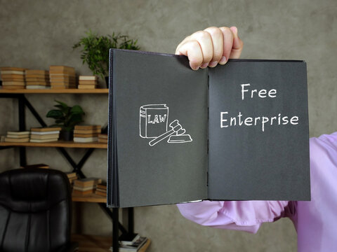  Juridical concept meaning Free Enterprise with phrase on the piece of paper.