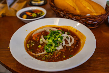 Plate of Vietnamese stewed beef brisket soup served with bread