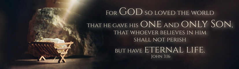 Christian Christmas concept. Birth of Jesus Christ. Wooden manger in cave background. Banner....