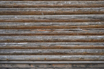 Natural dark background pattern of a log without bark and with a natural stain finish.