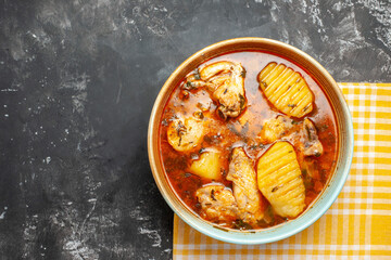 Mouth-watering soup on yellow stripped towel on the right corner