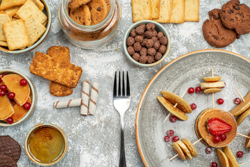 Above view of breakfast time with stuffy pancakes cookies biscuits on blue backgrounds