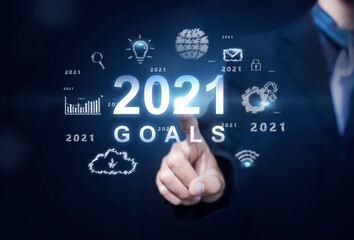Business and Technology target set goals and achievement in 2021 new year resolution, planning and start up strategies and ideas graphic icon design concept businessman copy space blue background