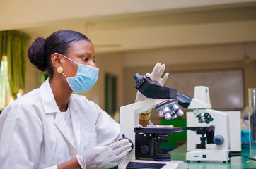 two young african health care researchers working in life science laboratory about the cure of the...