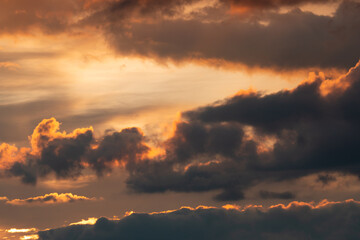 clouds with black clouds at sunset as background