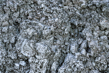 mountain textures of stones with interlayers of gypsum, colored quartz, clay, sand and other layers of various ores, with different textures, color and density, in gypsum ore quarry.
