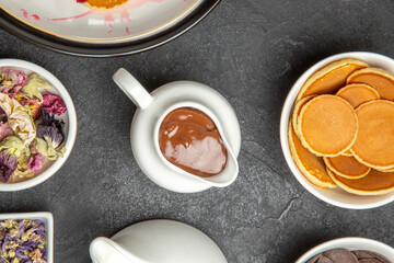 top view yummy pancakes with cup of tea on dark background sweet pie dessert cakes