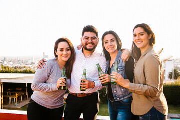 Fototapeta premium Group of Mexican friends having party on rooftop in Mexico