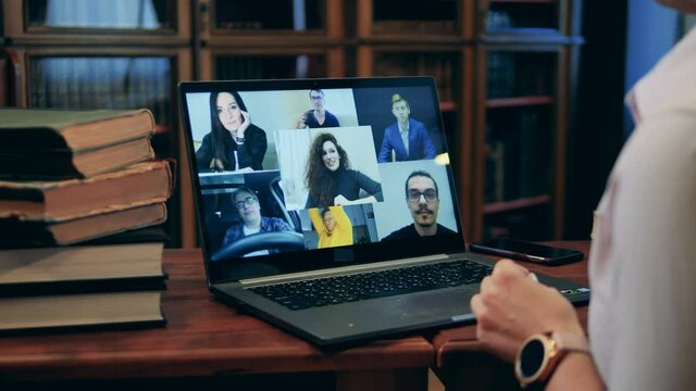 Students listening to instructor, smiling, sharing ideas during online lecture. Closeup of laptop screen