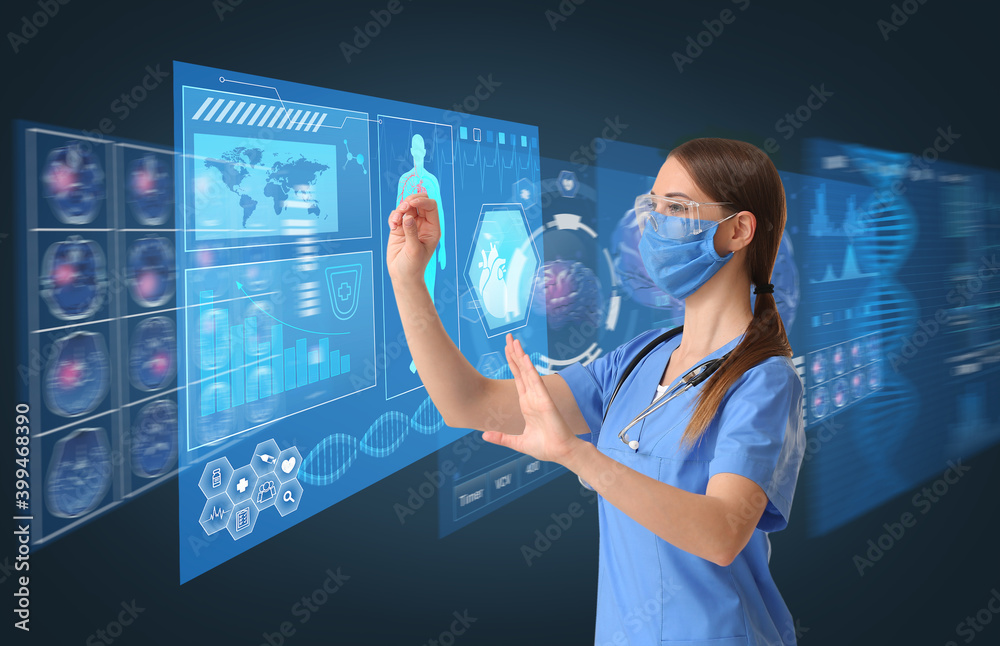 Wall mural Young female doctor using virtual screen on dark background