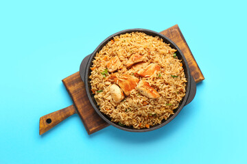 Bowl with tasty pilaf on color background