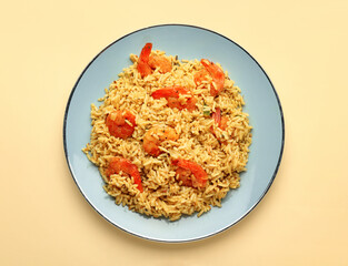 Plate with tasty pilaf on color background