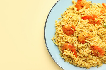 Plate with tasty pilaf on color background