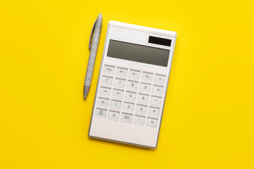 Digital calculator and pen on color background