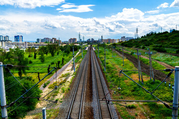 Fototapeta na wymiar Straight railroad track in industrial area of city