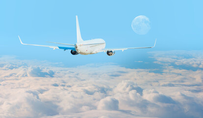 White passenger airplane over the clouds  - Travel by air transport