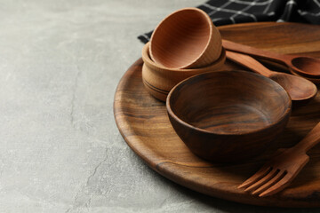 Towel and wooden kitchenware on gray table