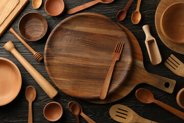 Different wooden kitchenware on wooden table, top view