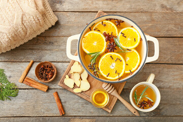 Hot mulled wine on wooden background