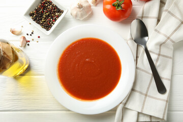 Concept of tasty dinner with tomato soup on wooden background