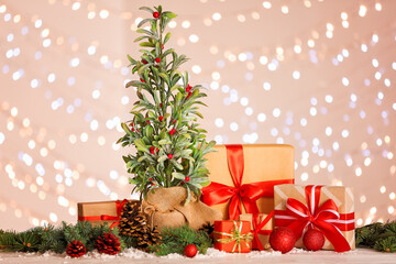 Beautiful Christmas composition with mistletoe plant against blurred lights