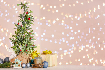 Beautiful Christmas composition with mistletoe plant against blurred lights