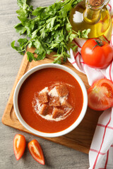 Concept of tasty food with tomato soup on gray background
