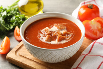 Concept of tasty food with tomato soup on gray background