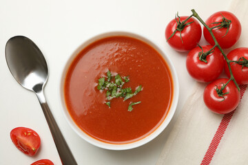 Concept of tasty food with tomato soup on white background