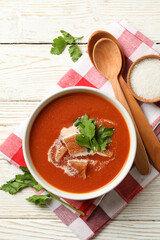 Concept of tasty food with tomato soup on wooden background
