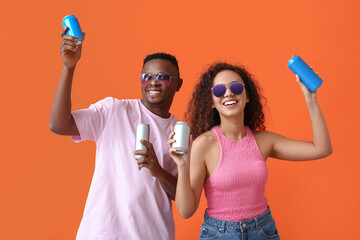 African-American couple with soda on color background